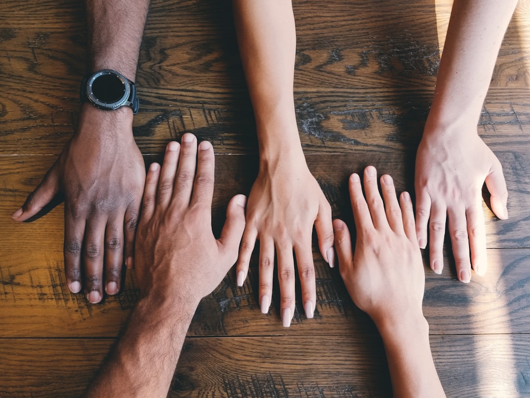 Diverse adults standing together in mutual support
