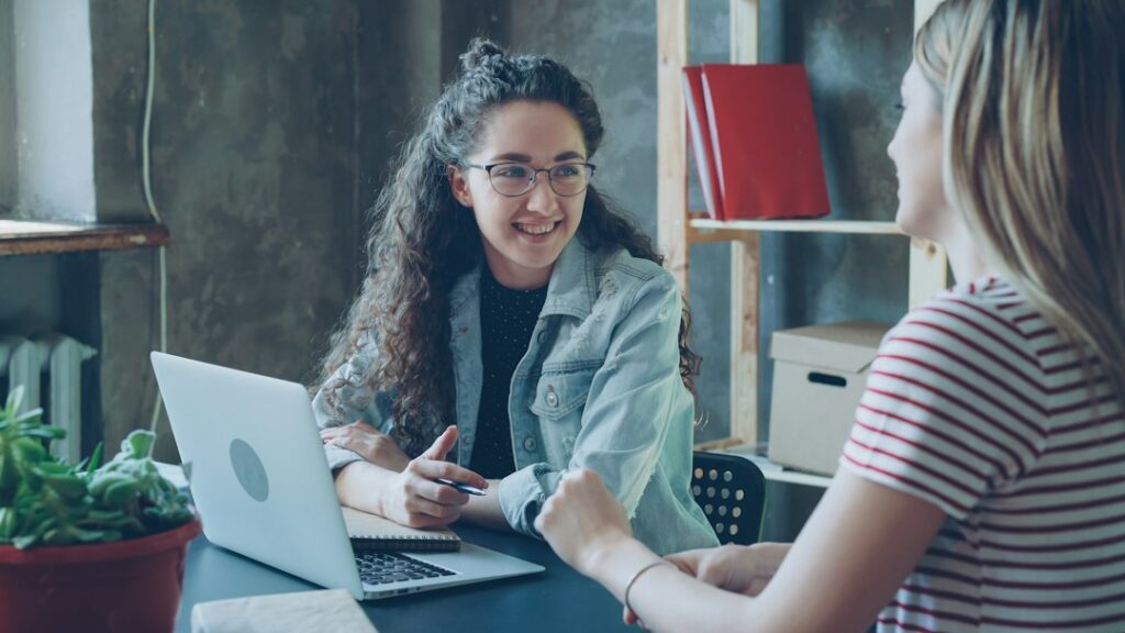 Two Black women having a supportive professional conversation
