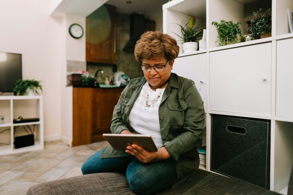 Older adult using a tablet at home as part of in-home support
