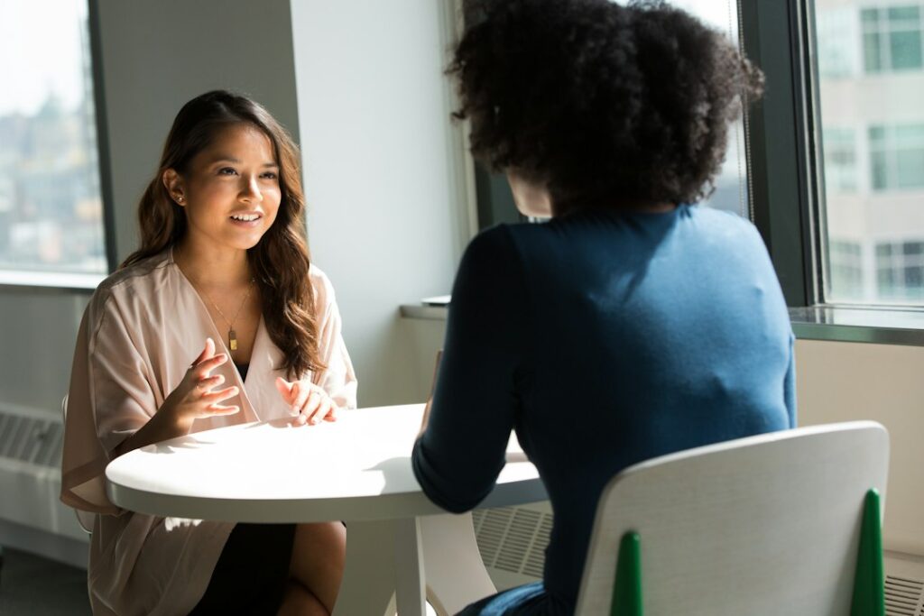 Two Black women in a supportive care conversation